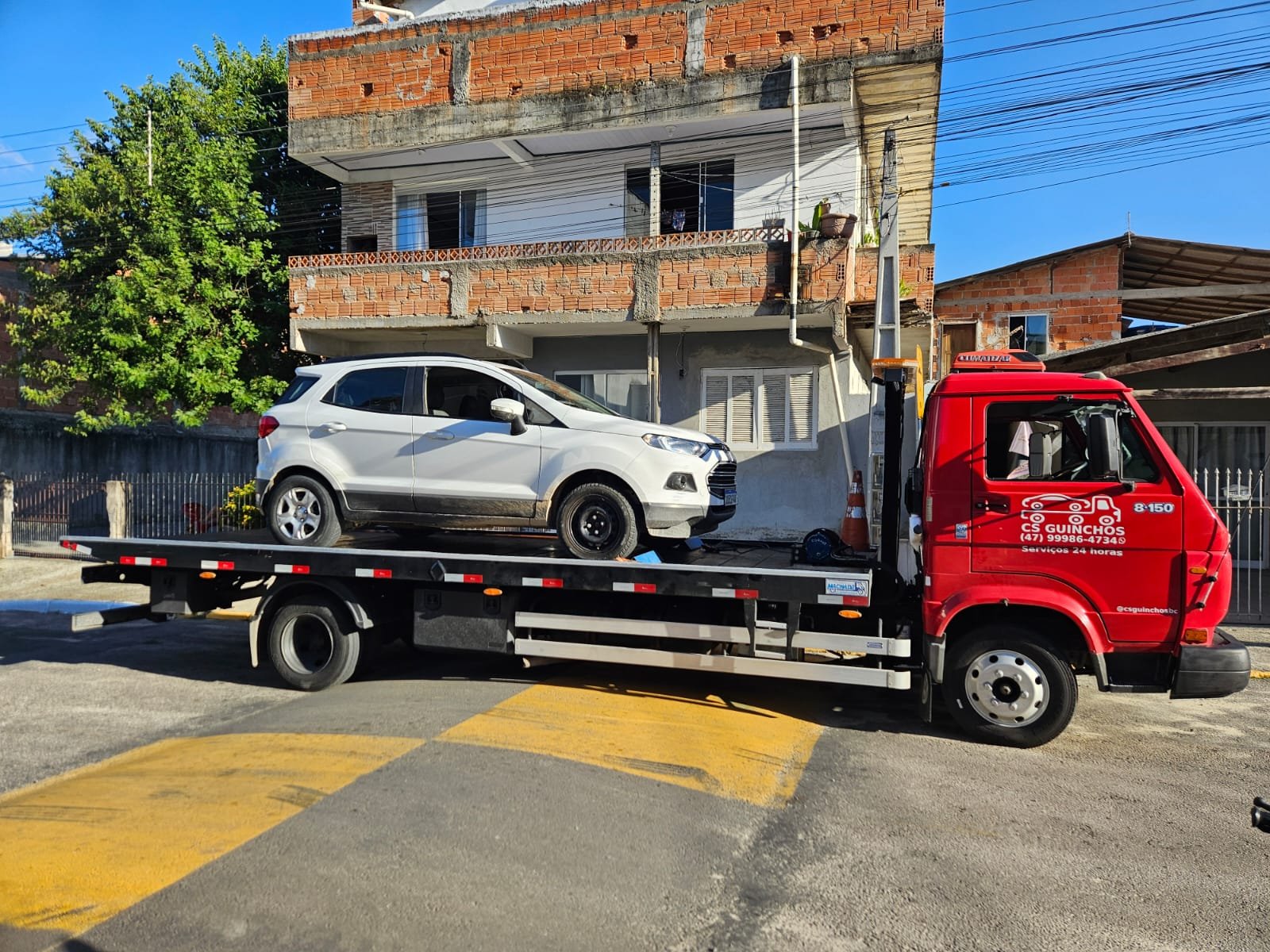 Caminhão plataforma da CS Transportadora transportando um veículo em Santa Catarina