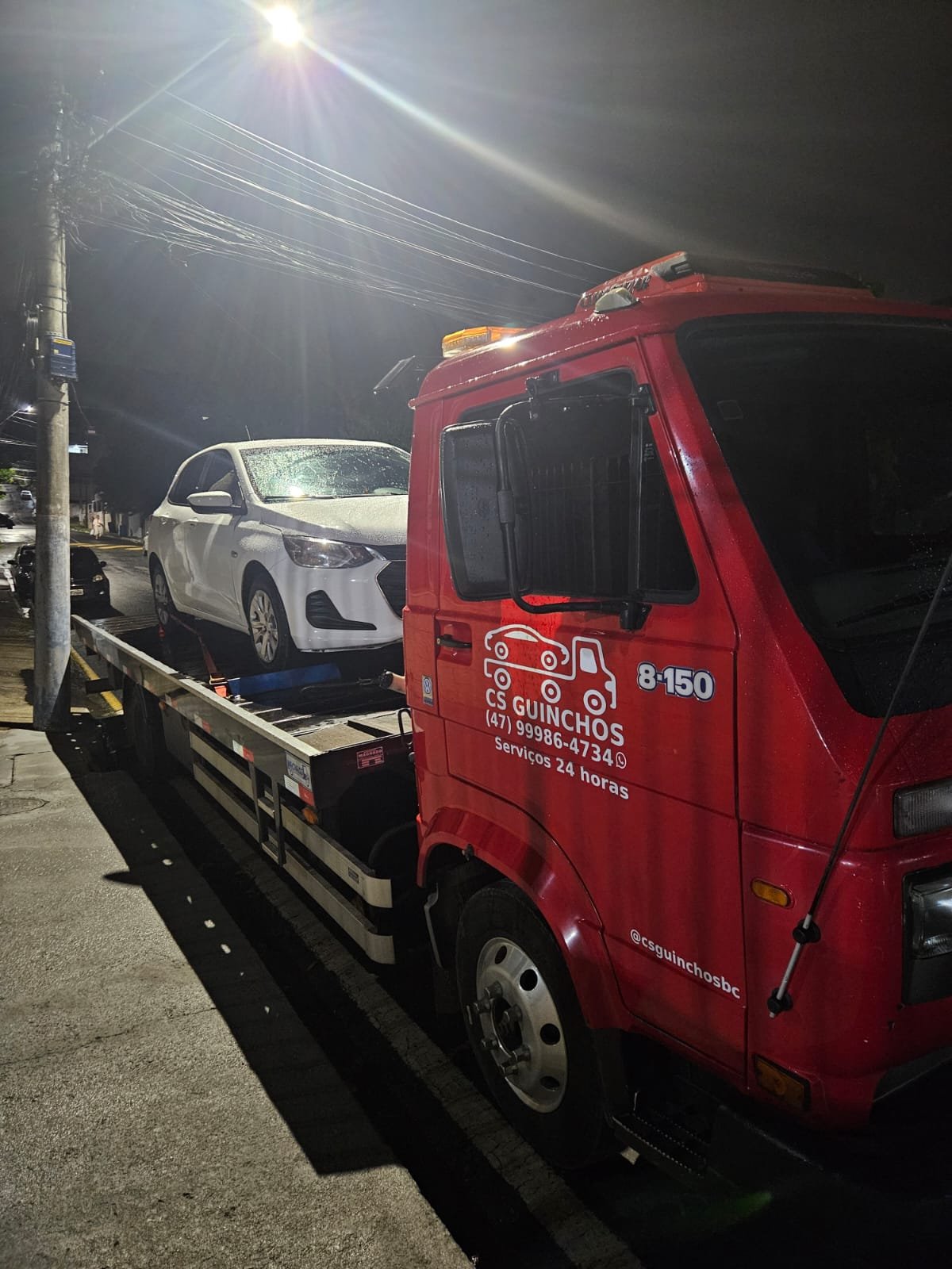 Caminhão plataforma da CS Transportadora transportando um veículo em Santa Catarina